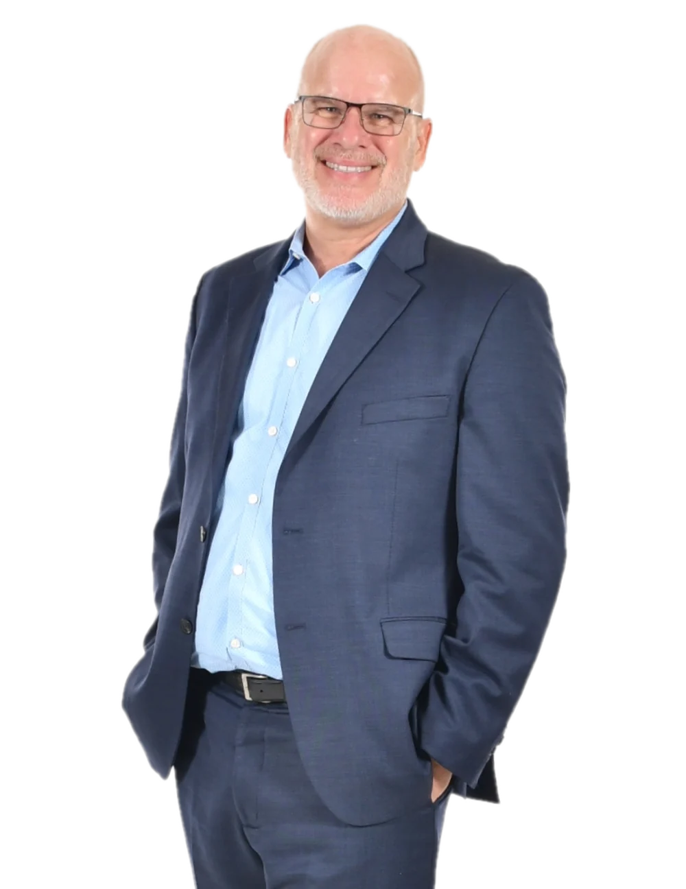 Dave Petkovsek standing in a navy suit and light blue shirt, hands in his pockets, smiling